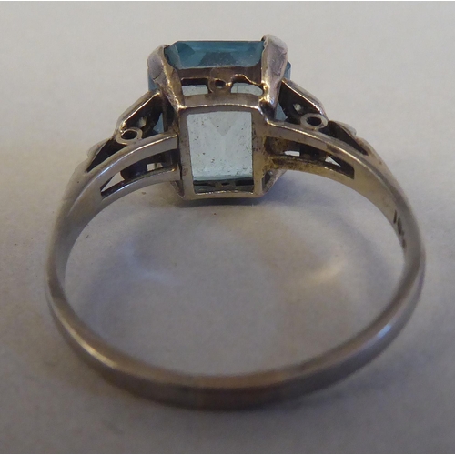 81 - A white gold claw set ring with a single stone aquamarine and diamond ring  stamped 18ct; and a whit... 