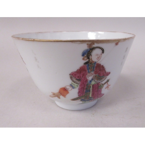 85 - An 18thC Chinese porcelain footed wine cup, decorated with a female and male figure and calligraphy ... 