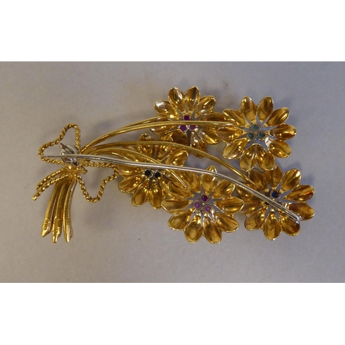 86 - An 18ct textured gold floral brooch, set with coloured stones 