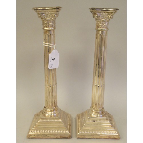 9 - A pair of modern loaded silver candlesticks with detachable bead bordered sconces, Corinthian capita... 