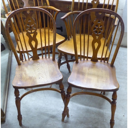 31 - Two pairs of late 19th/early 20thC beech and elm framed hoop, wheel, splat and spindle back Windsor ... 