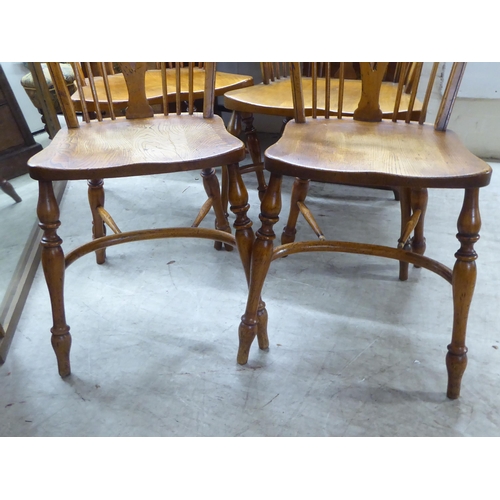 31 - Two pairs of late 19th/early 20thC beech and elm framed hoop, wheel, splat and spindle back Windsor ... 