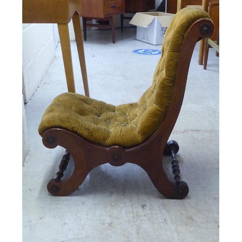 36 - A late Victorian walnut showwood framed nursing chair, upholstered in old gold coloured fabric, rais... 