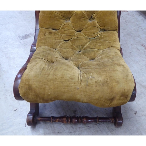 36 - A late Victorian walnut showwood framed nursing chair, upholstered in old gold coloured fabric, rais... 