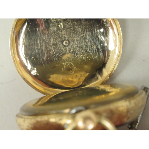 45 - A 14ct gold cased fob watch with bright-cut engraved floral, scrolled and other ornament, faced by a... 