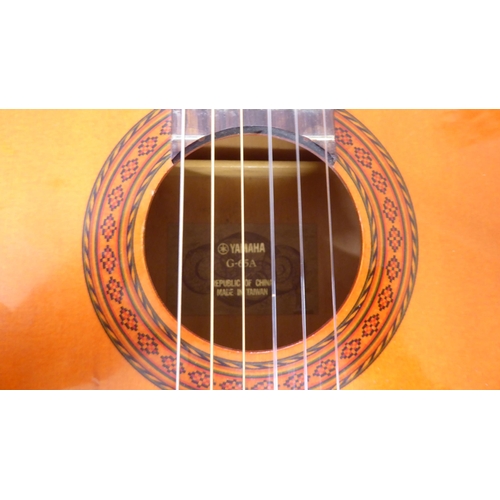 46 - A Yamaha six string acoustic guitar, model No. G.65A with a carrying case
