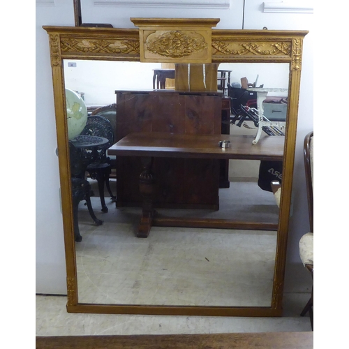48 - A 19thC overmantle mirror, set in a decorated bead moulded gilt frame  63