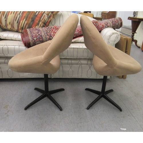 52 - A pair of 1960s moulded, mushroom coloured fabric upholstered office reception chairs, raised on tub... 