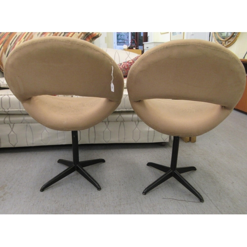 52 - A pair of 1960s moulded, mushroom coloured fabric upholstered office reception chairs, raised on tub... 