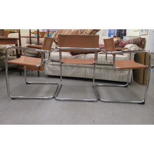57 - A set of three modern open arm office reception chairs with sprung, tubular stainless steel framed a... 