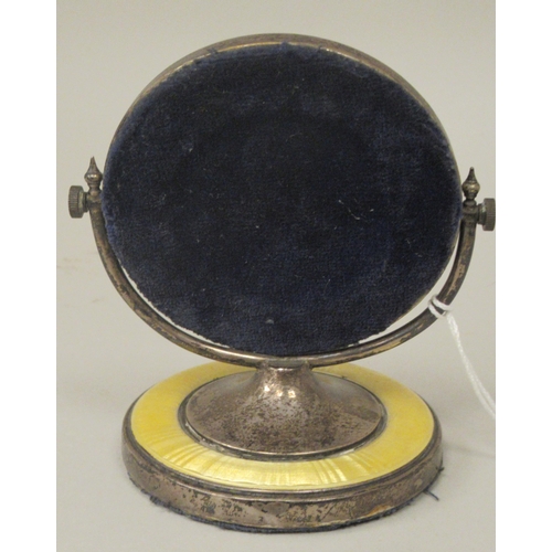 59 - A silver and engine turned, yellow enamel dressing table mirror of small proportions, the circular p... 