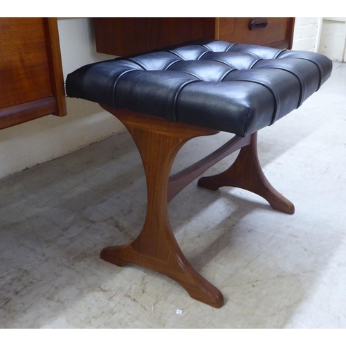 7 - A 1970s teak dressing table surmounted by a rectangular mirror, over four drawers, raised on tapered... 