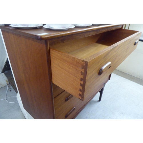 9 - A 1970s teak four drawer dressing chest, raised on tapered legs&nbsp; 41