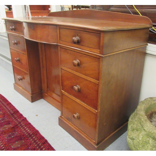 10 - A late Victorian mahogany bow front sideboard, the central, recessed cupboard, flanked by an arrange... 