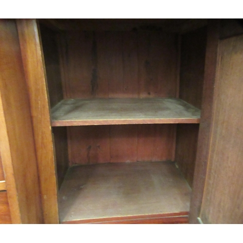 10 - A late Victorian mahogany bow front sideboard, the central, recessed cupboard, flanked by an arrange... 