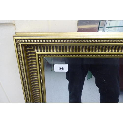 106 - A modern mirror, the bevelled plate set in a moulded gilt frame  27