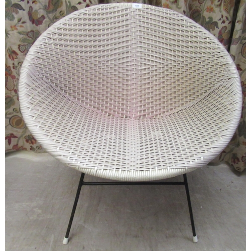 107 - A vintage design wicker effect tub chair, on tubular metal legs 