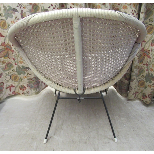 107 - A vintage design wicker effect tub chair, on tubular metal legs 