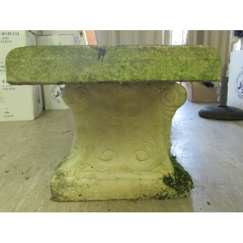 118 - A composition stone terrace bench, the rectangular seat raised on two pedestals  17