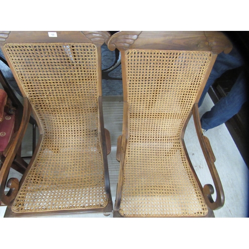 122 - A pair of late 19thC Indian Colonial fruitwood framed chairs, each with a woven cane back and seat, ... 