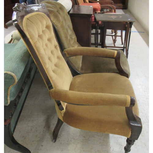 128 - Two similar late Victorian ebonised framed salon chairs, upholstered in a gold coloured fabric, rais... 