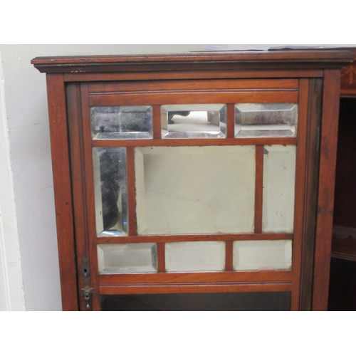 131 - A late Victorian walnut music cabinet with a mirrored and glazed door, raised on square legs  3... 