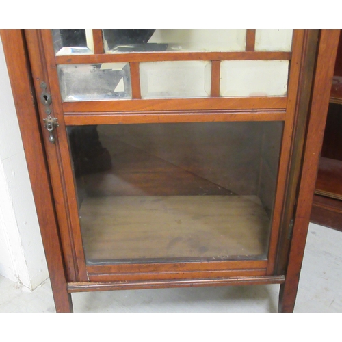 131 - A late Victorian walnut music cabinet with a mirrored and glazed door, raised on square legs  3... 