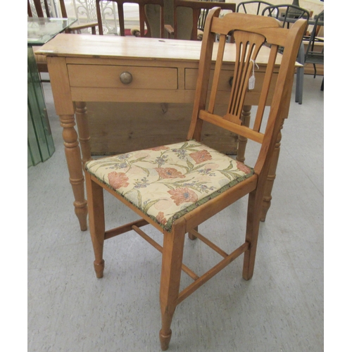 15 - An early 20thC waxed pine side table, the planked top over two inline drawers, raised on ring turned... 