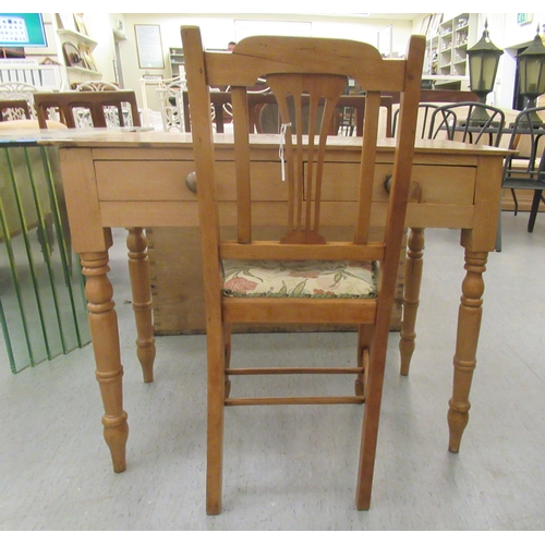 15 - An early 20thC waxed pine side table, the planked top over two inline drawers, raised on ring turned... 