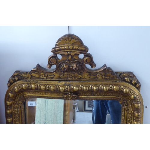 150 - A 19thC and later mirror, the bevelled plate set in a moulded gilt frame  25