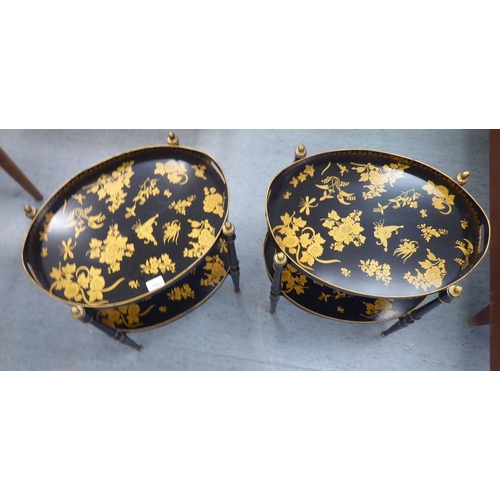 152 - A pair of antique inspired black painted metal and gilded twin tray top occasional tables, raised on... 