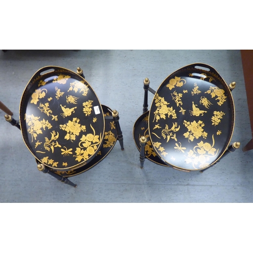 152 - A pair of antique inspired black painted metal and gilded twin tray top occasional tables, raised on... 