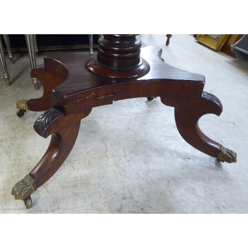 163 - An early/mid 19thC mahogany tea table, the rotating foldover top raised on quadruped base, splayed f... 