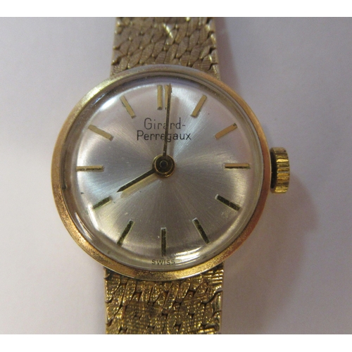 178 - A lady's Girard Perregaux 9ct gold cased and strapped wristwatch, faced by a baton dial