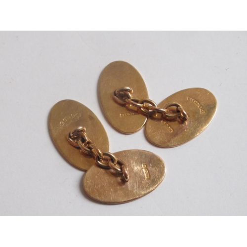 18 - A pair of 9ct gold oval tablet and chain cufflinks, with engine turned decoration  boxed