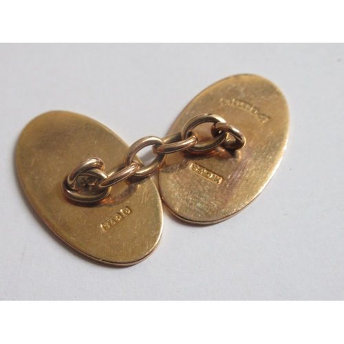 18 - A pair of 9ct gold oval tablet and chain cufflinks, with engine turned decoration  boxed