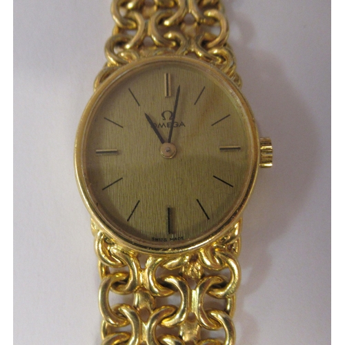 180 - A lady's Omega 18ct gold cased and strapped wristwatch, faced with a stick and baton dial