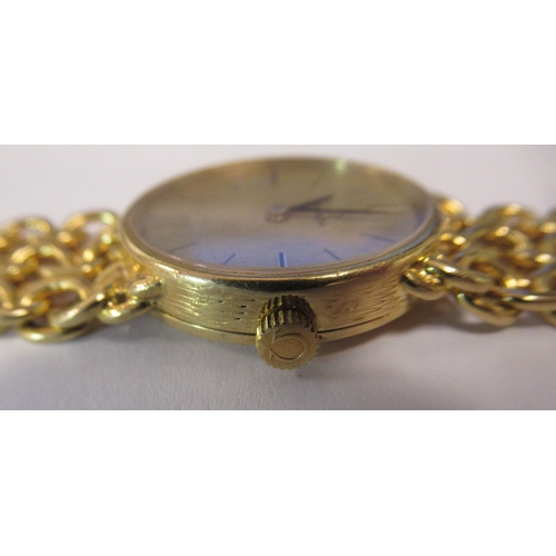 180 - A lady's Omega 18ct gold cased and strapped wristwatch, faced with a stick and baton dial