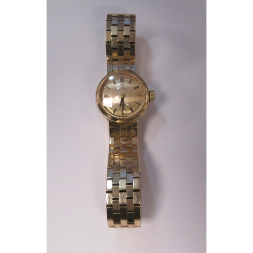 183 - A lady's Omega Ladymatic 9ct gold cased and strapped wristwatch, faced by a baton dial