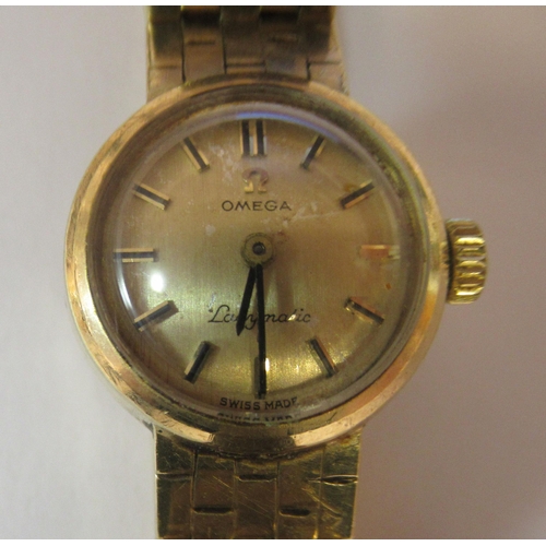 183 - A lady's Omega Ladymatic 9ct gold cased and strapped wristwatch, faced by a baton dial