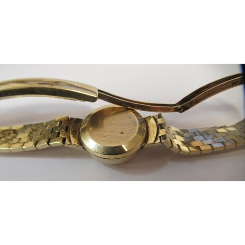 183 - A lady's Omega Ladymatic 9ct gold cased and strapped wristwatch, faced by a baton dial