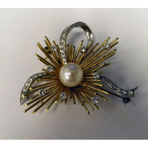 184 - A bi-coloured metal brooch, in a sunburst and ribbon style, set with a central cultured pearl, surro... 