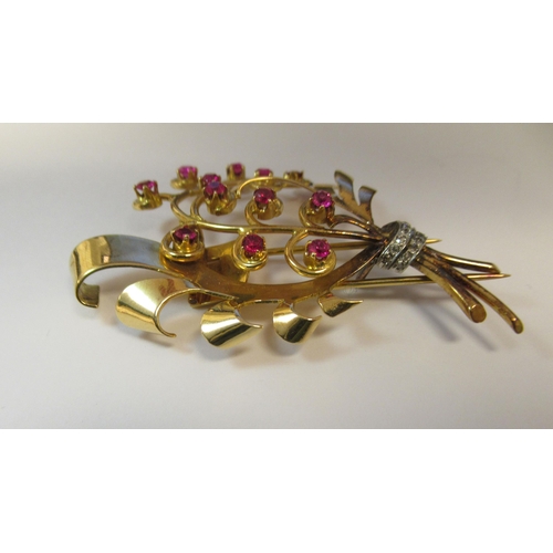 185 - A yellow metal brooch, shaped as a bouquet, set with rubies and diamonds