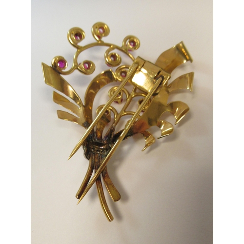 185 - A yellow metal brooch, shaped as a bouquet, set with rubies and diamonds