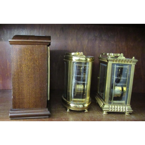 196 - Clocks: to include a carriage timepiece with a lacquered brass case and glass panels  4.5