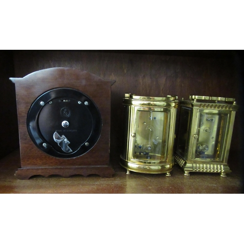 196 - Clocks: to include a carriage timepiece with a lacquered brass case and glass panels  4.5