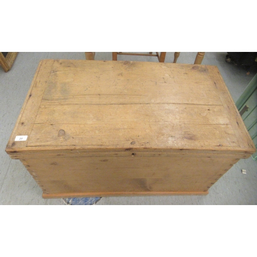 20 - An early 20thC boarded, waxed pine chest with straight sides and a hinged lid  21