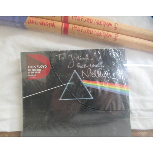 21 - A Pink Floyd framed tribute  comprising a T-shirt bearing a David Gilmour signature; two drumsticks ... 