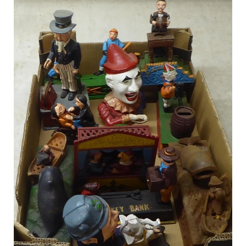 216 - A collection of reproduction cast iron and overpainted novelty money boxes: to include one fashioned... 