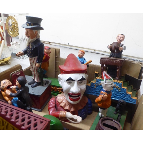 216 - A collection of reproduction cast iron and overpainted novelty money boxes: to include one fashioned... 